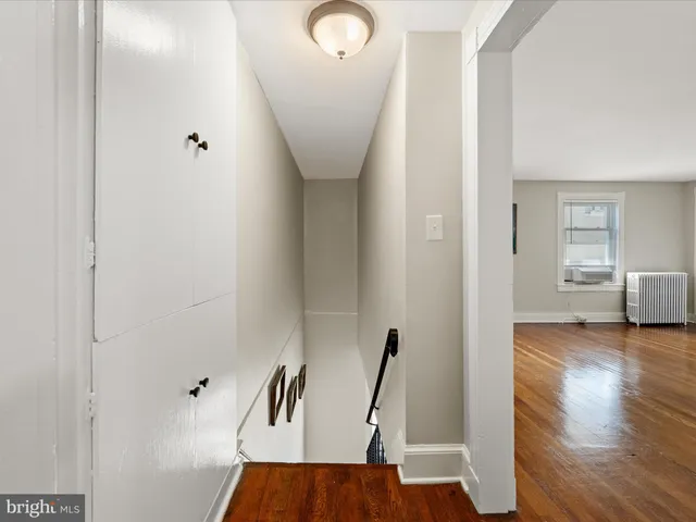 a view of a room with wooden floor and windows
