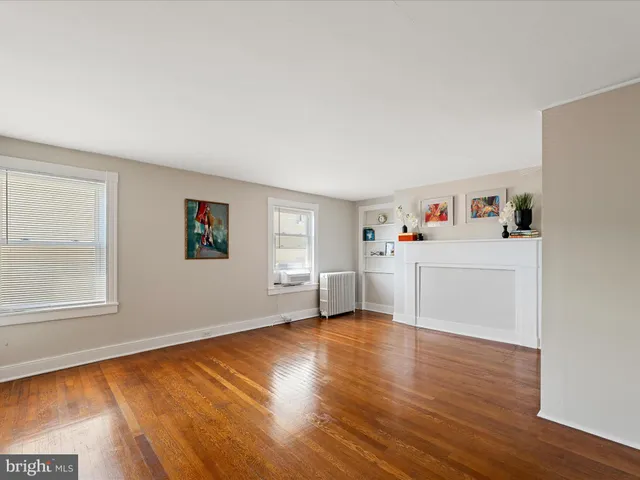 a view of a room with wooden floor and window