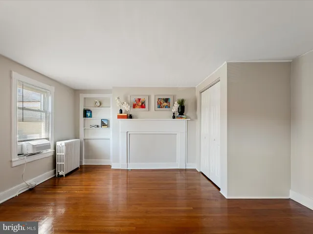 a view of a room with wooden floor and cabinet
