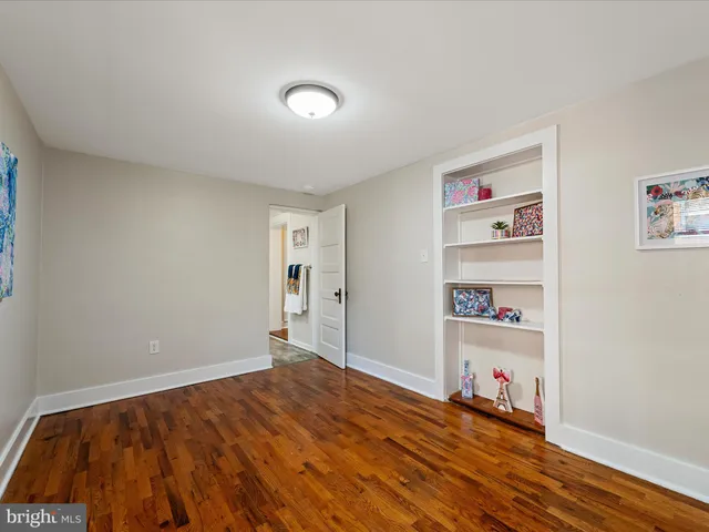 a bedroom with a bed and a book shelf