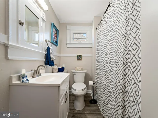 a bathroom with a toilet a sink and a mirror