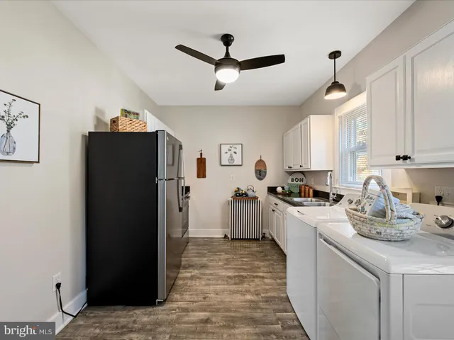 a kitchen with refrigerator cabinets and window
