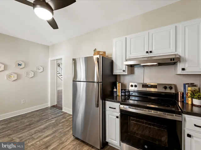 a kitchen with a stove and a refrigerator