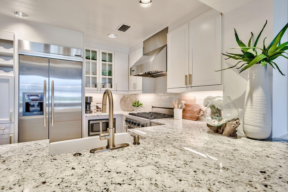 337 Bridge Lane, Unit 102B Inlet Beach, FL 32461 - Photo 22 of 50 a kitchen with stainless steel appliances kitchen island granite countertop a refrigerator and a sink
