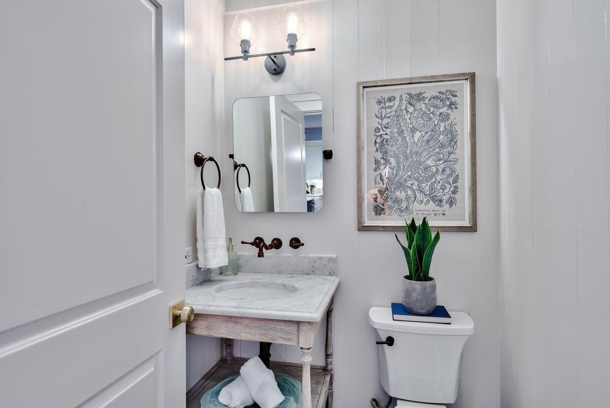 337 Bridge Lane, Unit 102B Inlet Beach, FL 32461 - Photo 23 of 50 a bathroom with a sink a toilet and mirror