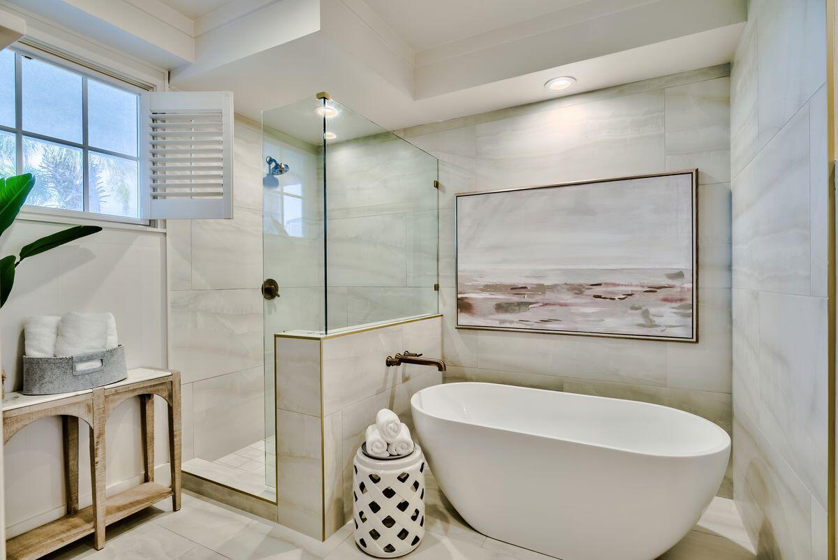 337 Bridge Lane, Unit 102B Inlet Beach, FL 32461 - Photo 35 of 50 a bathroom with a white tub a shower and a sink
