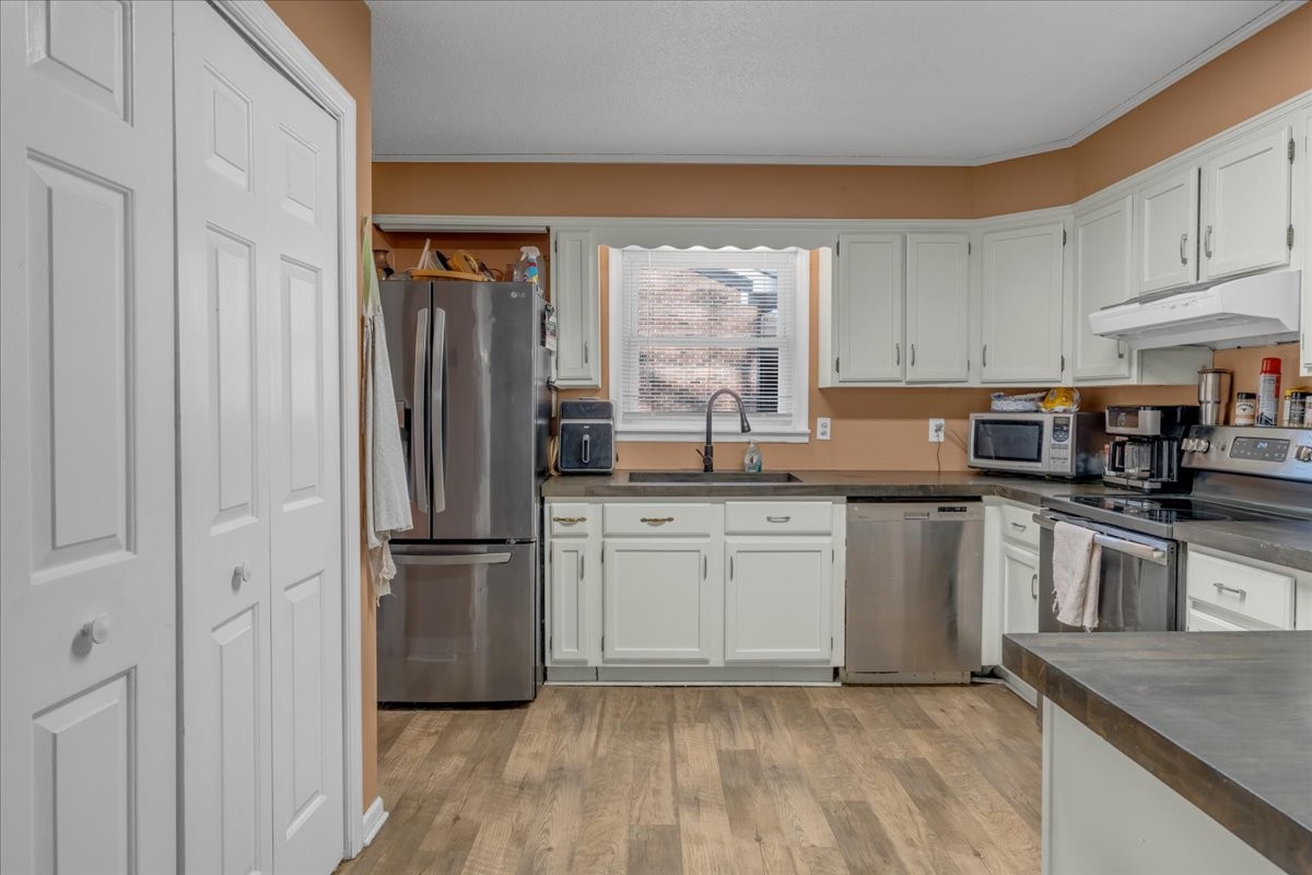 202 Mortons Lake Road Manchester, TN 37355 - Photo 17 of 41 a kitchen with granite countertop stainless steel appliances a sink refrigerator and microwave
