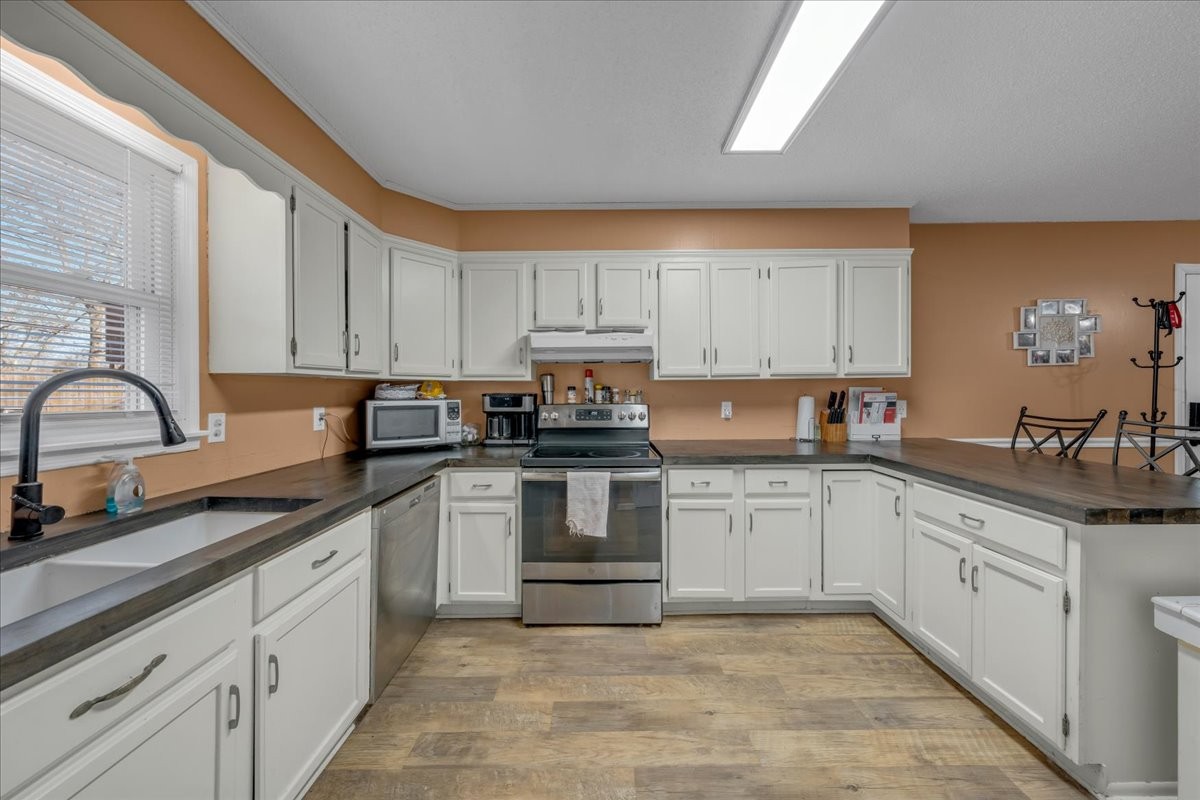 202 Mortons Lake Road Manchester, TN 37355 - Photo 21 of 41 a kitchen with granite countertop white cabinets and white appliances