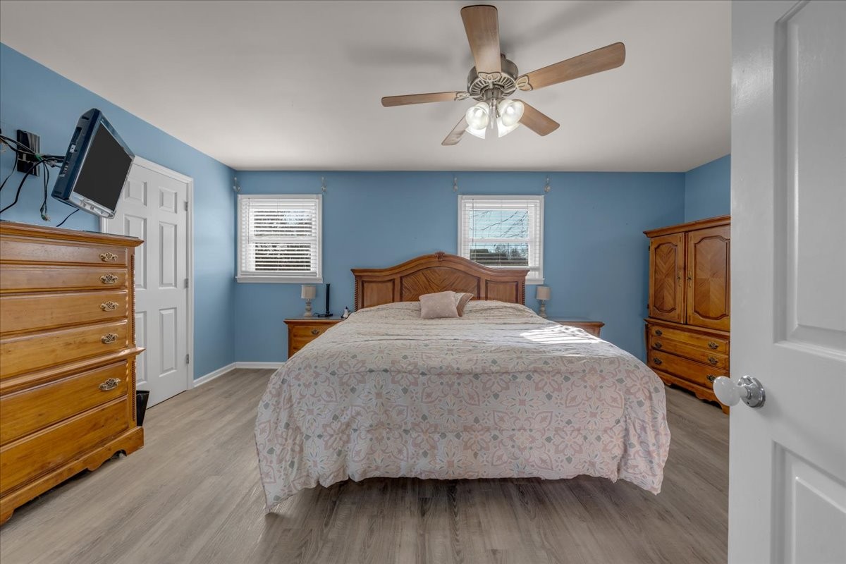 202 Mortons Lake Road Manchester, TN 37355 - Photo 24 of 41 a bedroom with a bed and wooden floor