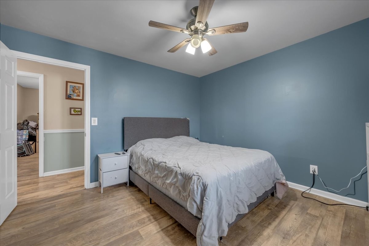 202 Mortons Lake Road Manchester, TN 37355 - Photo 33 of 41 a bedroom with a bed and a chandelier