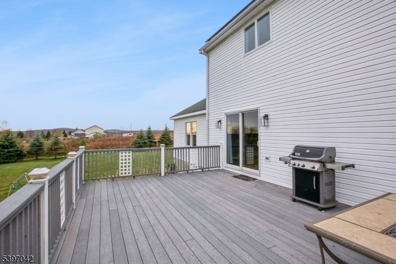 154 Lott Road Wantage, NJ 07461 - Photo 33 of 39 a view of a deck with wooden floor and a floor to ceiling window