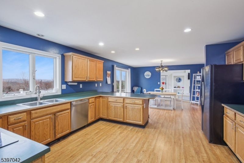 154 Lott Road Wantage, NJ 07461 - Photo 10 of 39 a kitchen with stainless steel appliances granite countertop a refrigerator a sink dishwasher a stove and white countertops with wooden floor