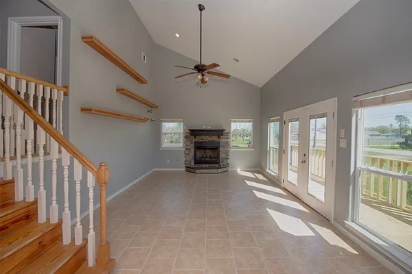 a view of a livingroom with furniture staircase and windows