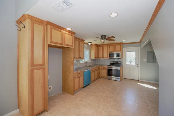 a kitchen with granite countertop a refrigerator and a stove
