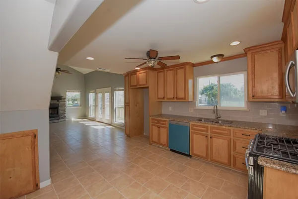 a view of a kitchen with a sink and cabinets