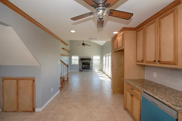 a view of a kitchen with a sink and a refrigerator