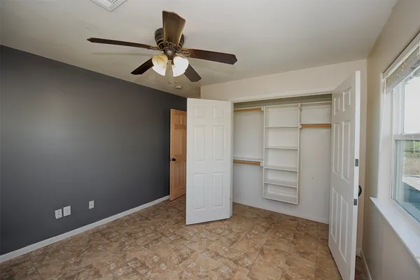 a view of an empty room and closet area