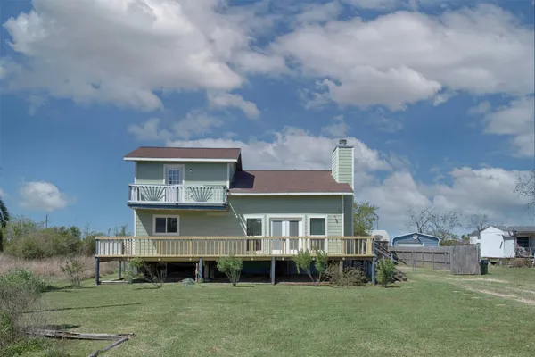 a aerial view of a brick house next to a yard