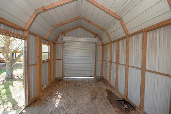 a view of small space with sliding door and tree