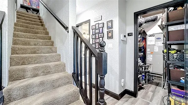 a view of staircase with lots of frames on wall