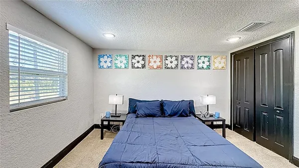 a bedroom with a bed and a window