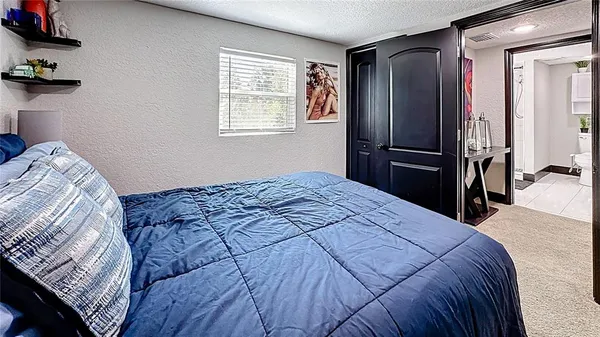 a bedroom with a bed and a dresser