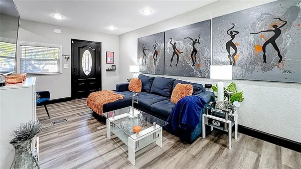 a living room with furniture and wooden floor