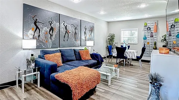 a living room with furniture and wooden floor
