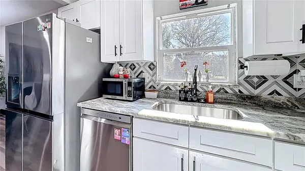 a kitchen with a refrigerator and a sink