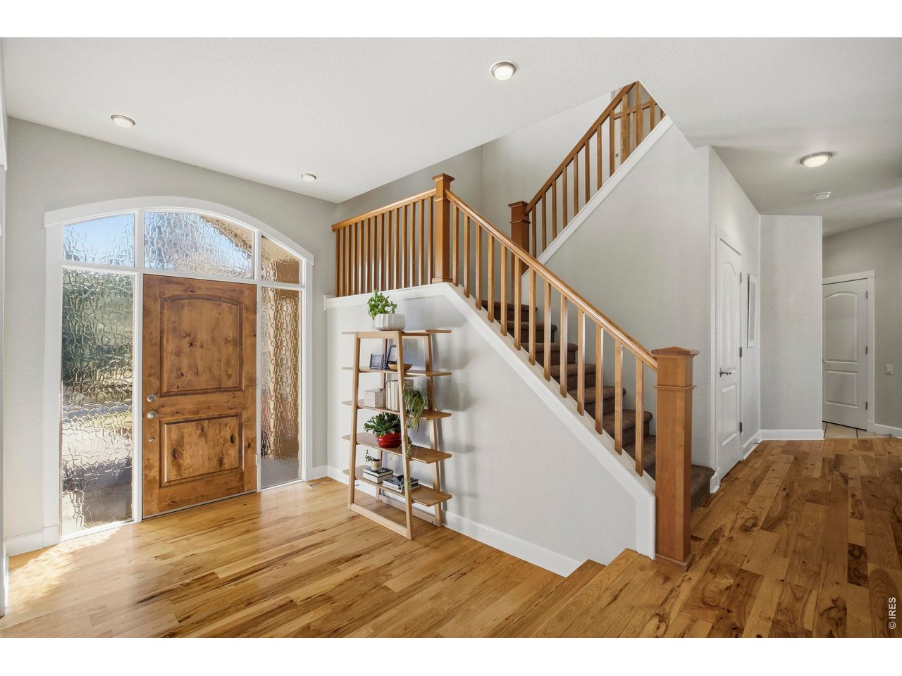 6580 Rookery Road Fort Collins, CO 80528 - Photo 5 of 44 Inviting entry showcasing warm hickory floors