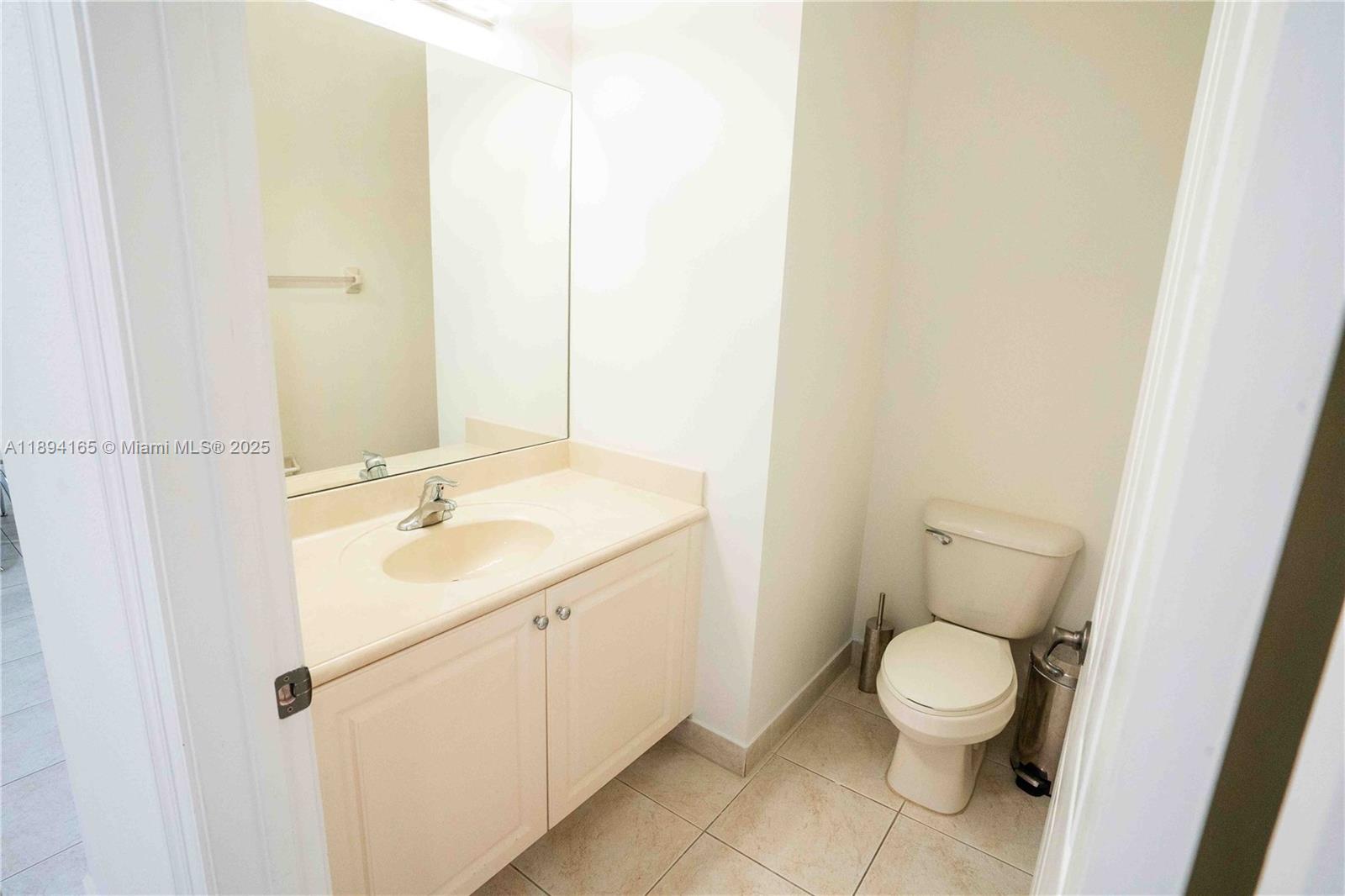 4537 Southwest 183rd Avenue Miramar, FL 33029 - Photo 12 of 46 a bathroom with a toilet sink and mirror