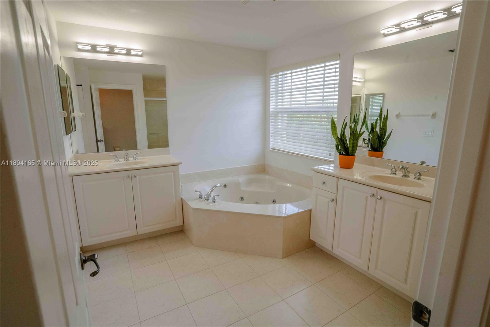 4537 Southwest 183rd Avenue Miramar, FL 33029 - Photo 19 of 46 a bathroom with a bathtub sink and mirror