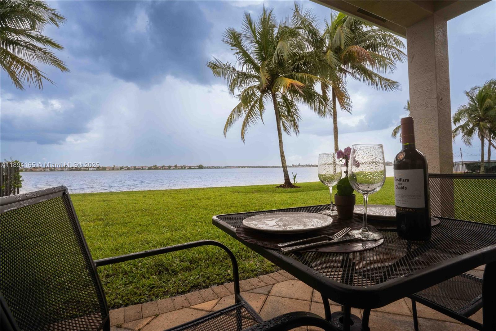 4537 Southwest 183rd Avenue Miramar, FL 33029 - Photo 28 of 46 a view of a swimming pool with a table and chairs
