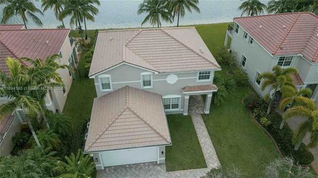 an aerial view of residential houses with outdoor space and swimming pool