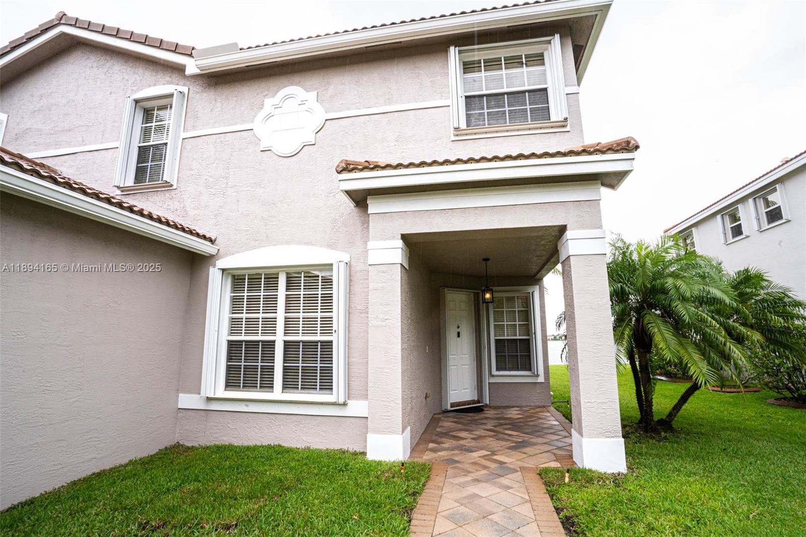 4537 Southwest 183rd Avenue Miramar, FL 33029 - Photo 4 of 46 a front view of a house with a garden