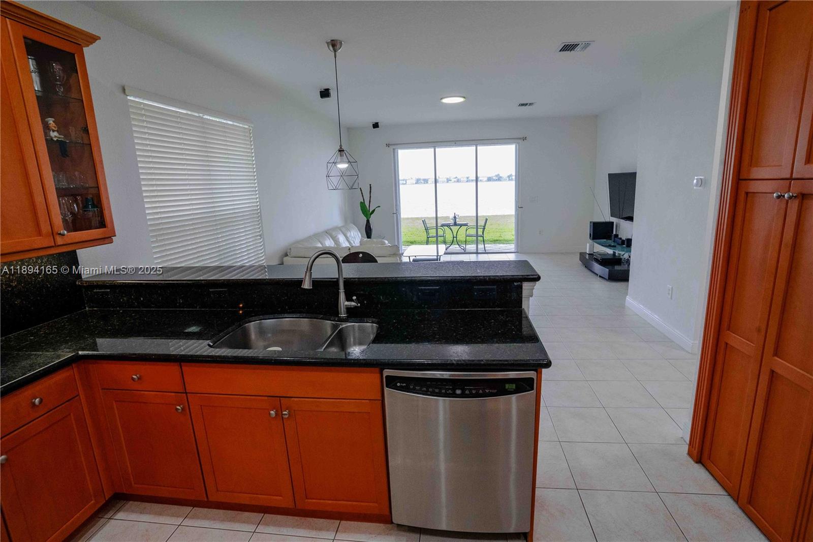 4537 Southwest 183rd Avenue Miramar, FL 33029 - Photo 5 of 46 a kitchen with granite countertop a sink stove and cabinets