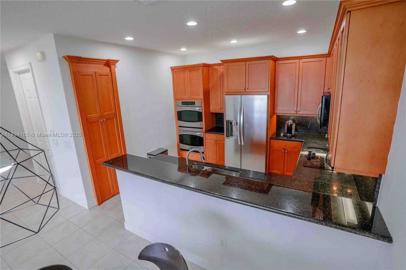 4537 Southwest 183rd Avenue Miramar, FL 33029 - Photo 6 of 46 a kitchen with stainless steel appliances granite countertop sink refrigerator and microwave