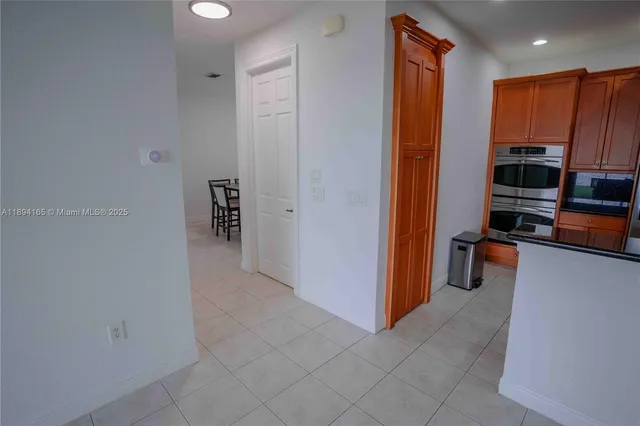 a view of kitchen with stainless steel appliances a refrigerator and cabinets