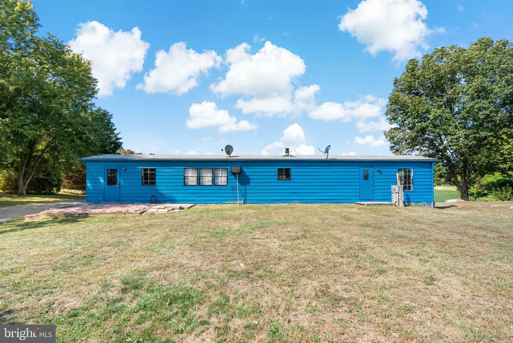 11431 Ashton Road Clear Spring, MD 21722 - Photo 5 of 41 Vibrant blue home under a sunny sky.