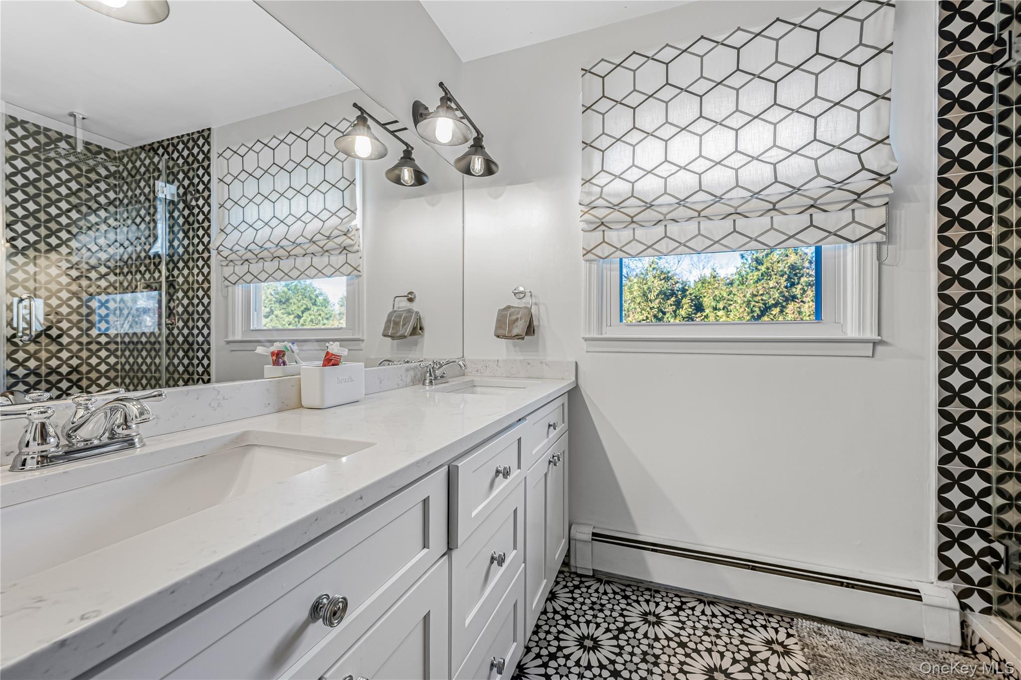 18 Woodland Road Roslyn, NY 11576 - Photo 15 of 21 a bathroom with a sink a vanity and a large mirror