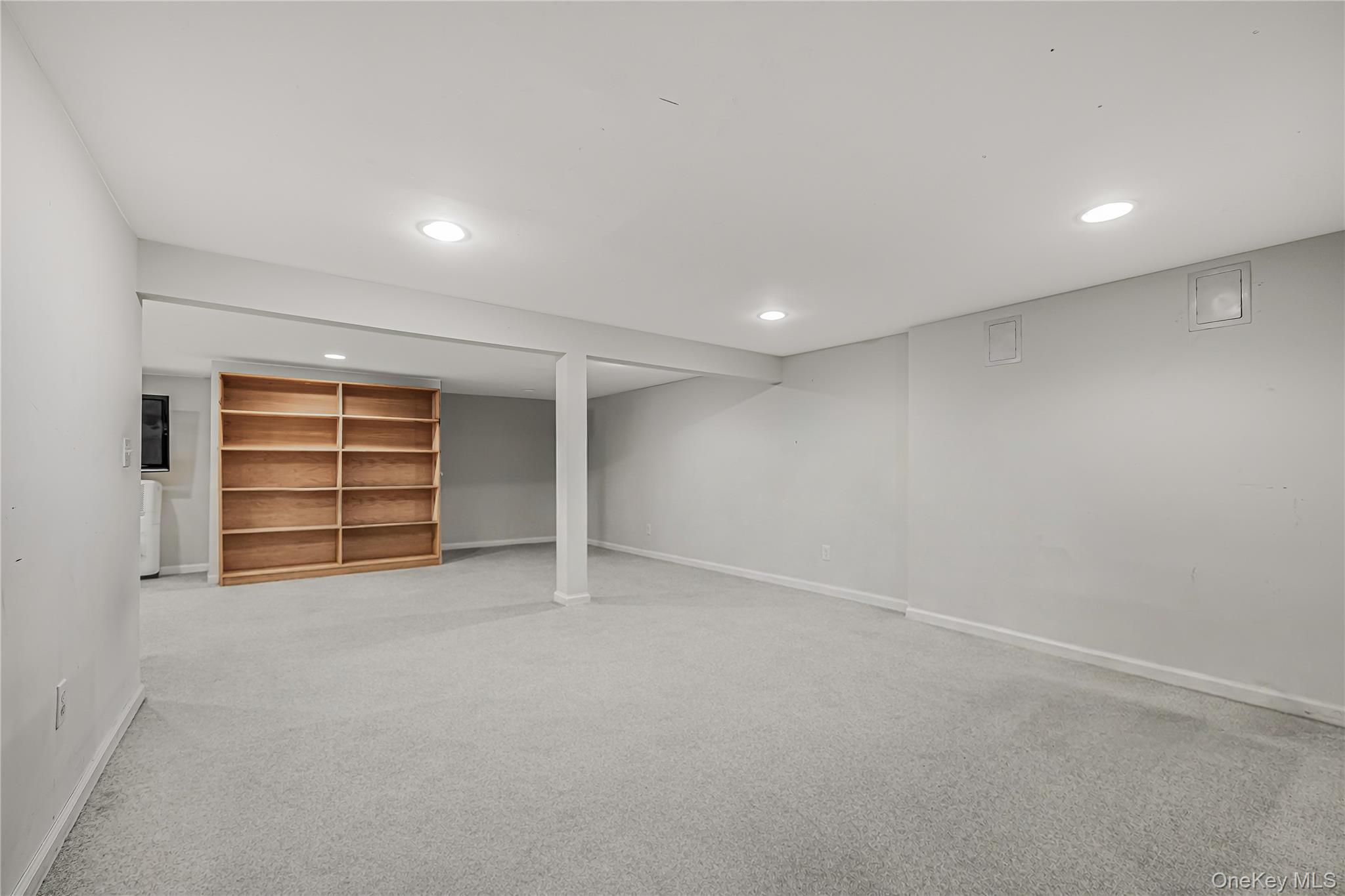 18 Woodland Road Roslyn, NY 11576 - Photo 19 of 21 wooden floor in an empty room with a window