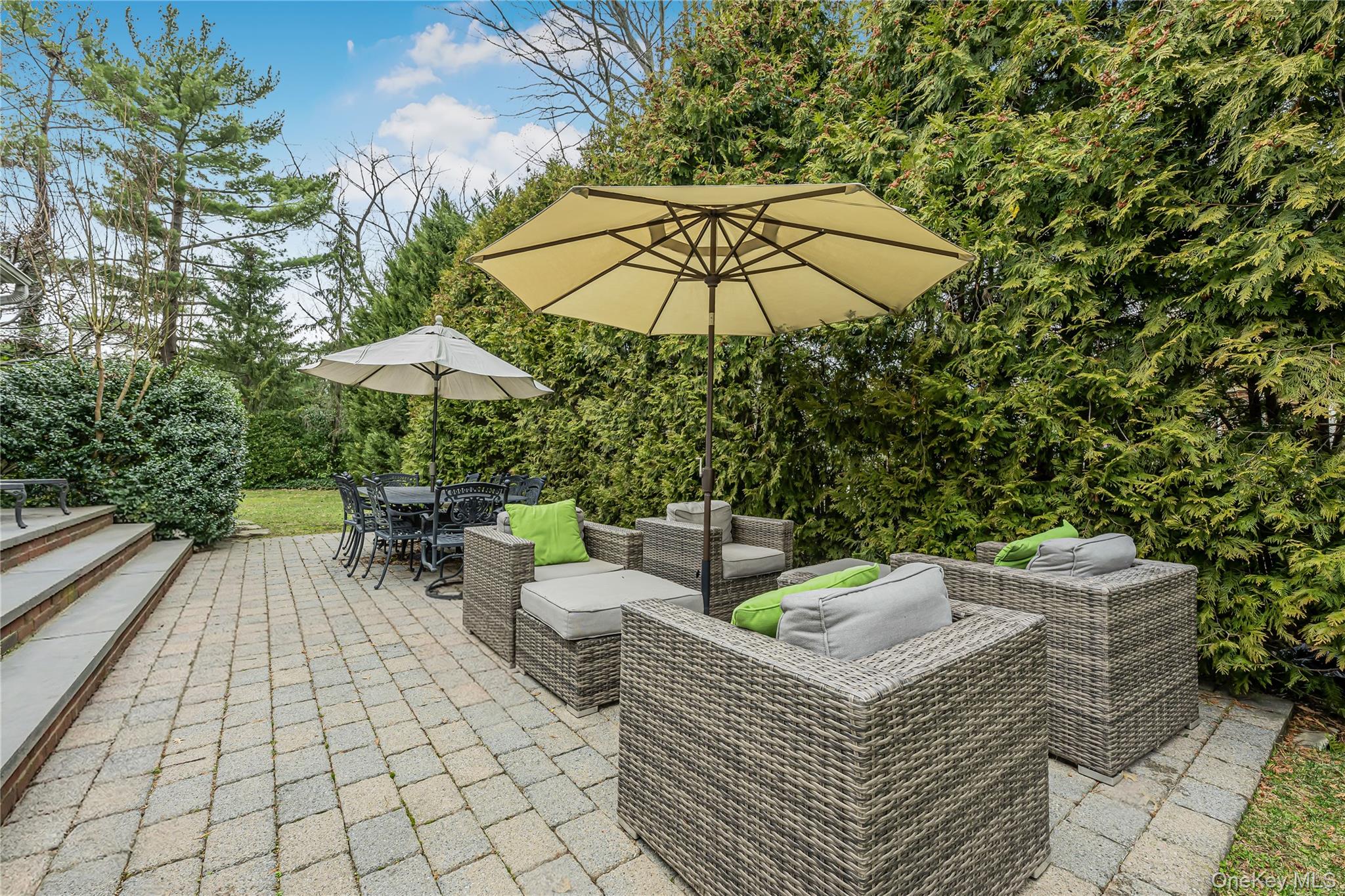 18 Woodland Road Roslyn, NY 11576 - Photo 21 of 21 an outdoor sitting area with furniture and umbrella