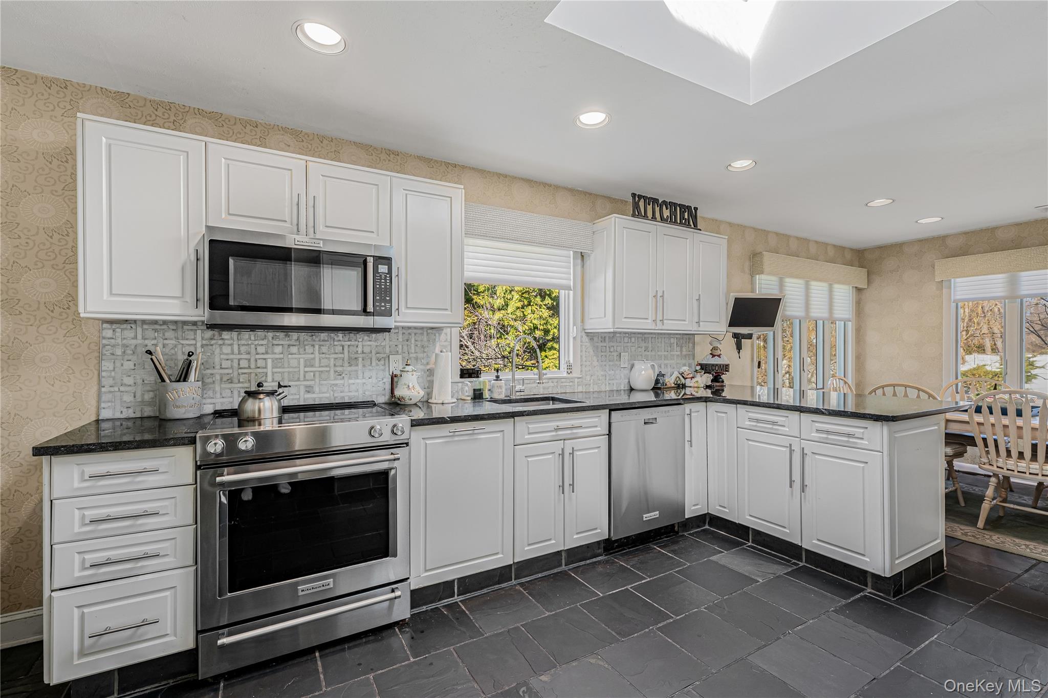 18 Woodland Road Roslyn, NY 11576 - Photo 5 of 21 a kitchen with granite countertop white cabinets white stainless steel appliances and a sink