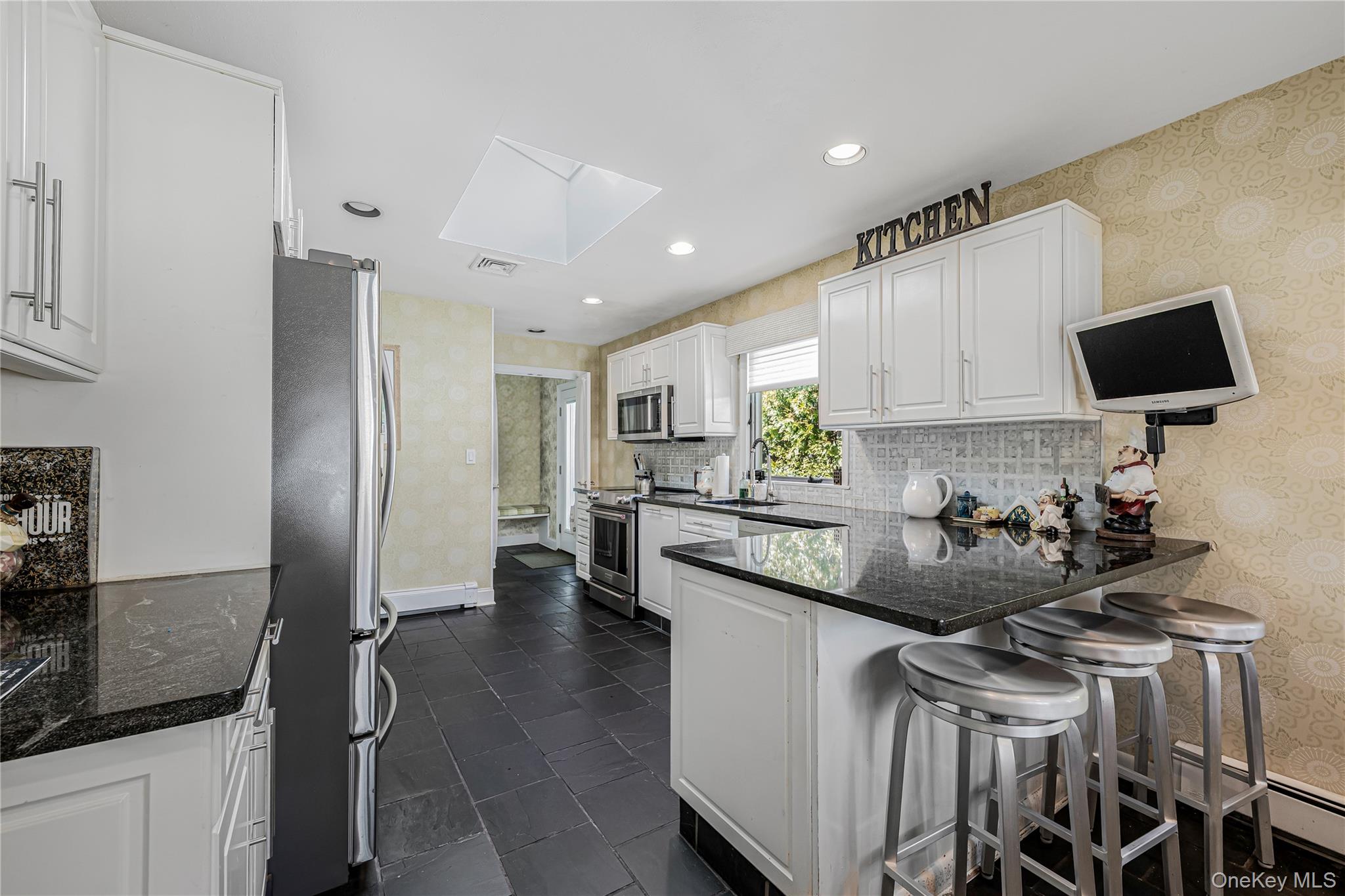 18 Woodland Road Roslyn, NY 11576 - Photo 6 of 21 a kitchen with a sink and cabinets