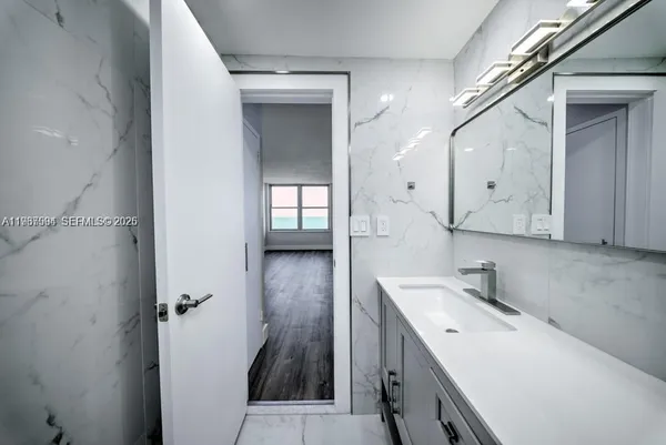 a room with a sink and a mirror