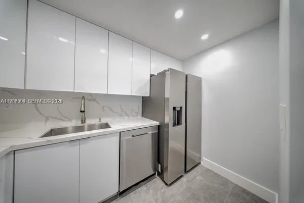 a kitchen with a sink and refrigerator