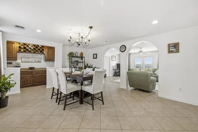 a view of a dining room with furniture and a chandelier