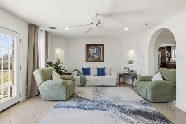 a living room with furniture and a large window