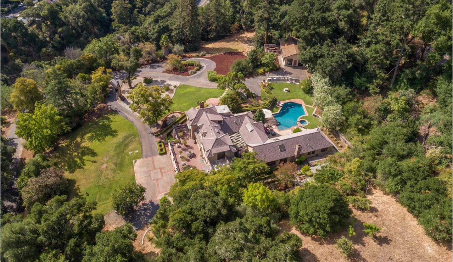 an aerial view of a house with yard swimming pool and outdoor seating