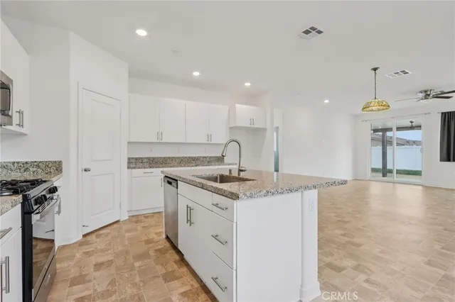 a kitchen with a sink stove and cabinets